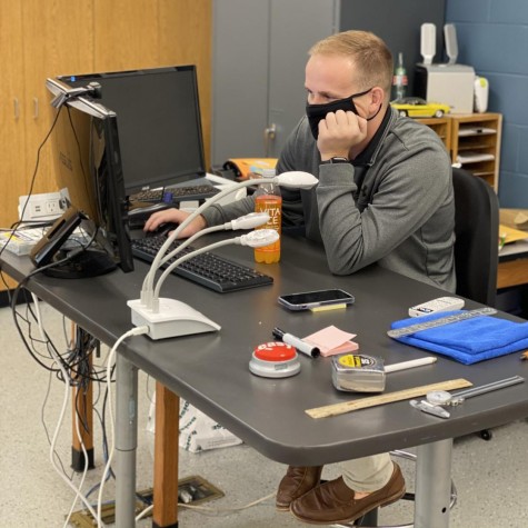 Teacher Grant Housman checks his 150 new emails in the morning.