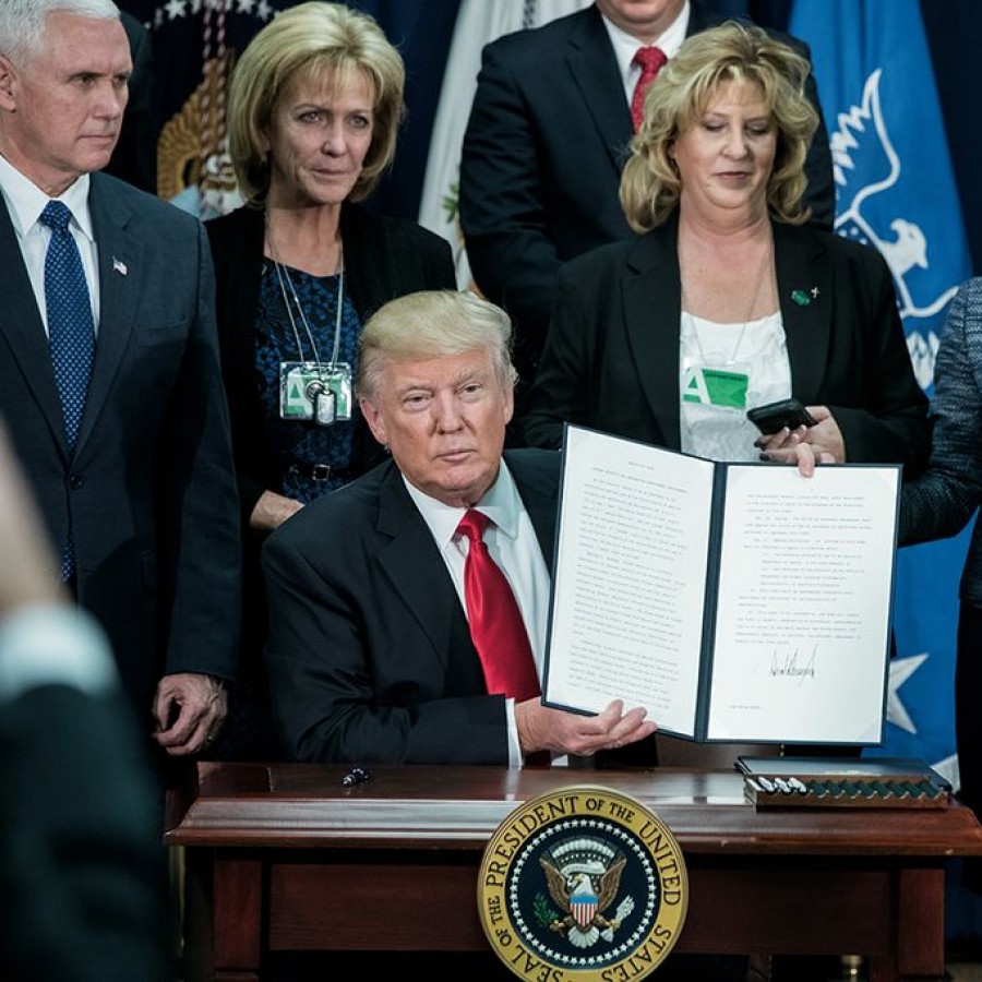 President Donald Trump signs the Border Security and Immigration Enforcement Improvements order on Jan. 25, 2017. 