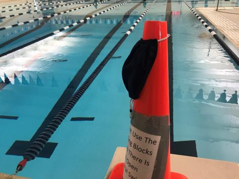In order to adhere to COVID guidelines, swimmers are required to wear masks up until they enter the water have to space themselves out across the pool. 