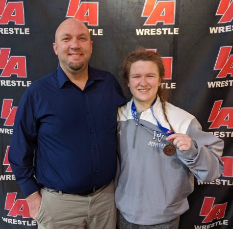 Junior Aine Moffitt and her coach, Tom Isaacson, after she placed 4th at the girls wrestling state championship tournament on Jan. 23 and 24.