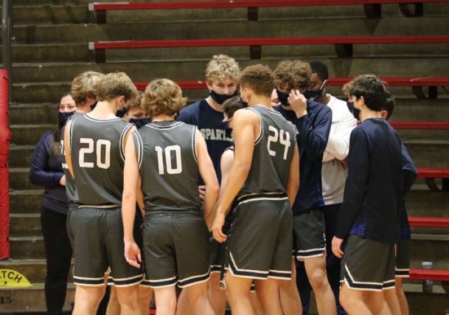 Pleasant Valley’s boys basketball team huddles to motivate and hype themselves up before returning to the court to face off against North Scott on Dec. 8, 2020.