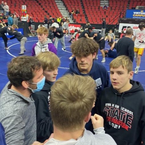 The PV state qualified wrestlers in huddles before the first day of wrestling at the state tournament.