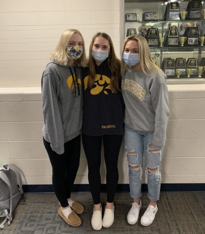 Emmie Peters, Sophia Lindquist and Paris Fietsam gather for a picture at school dressed in their Hawkeye gear