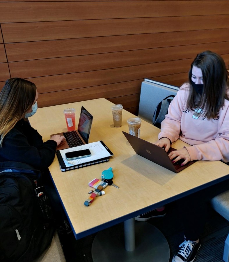 Seniors Reese Wendall and Anali Anderson drinking Starbucks and completing homework before class. 
