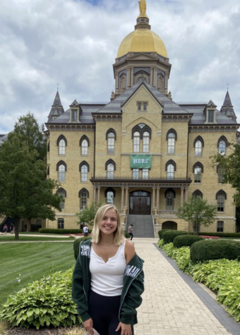 Emerson Peters stands hopeful in front of the Main Building at the University of Notre Dame during her prospective student visit.