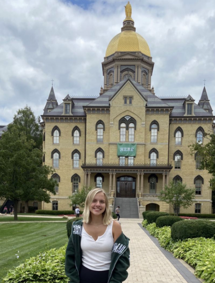 Emerson Peters stands hopeful in front of the Main Building at the University of Notre Dame during her prospective student visit.