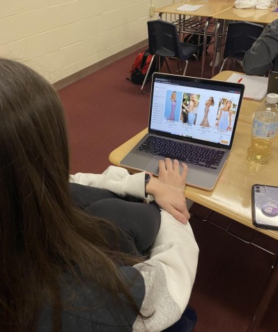 Senior Courtney Mohr looking for her prom dress during class