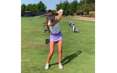 Junior Lizzie McVey works on executing the proper golfing technique while practicing for her next meet.