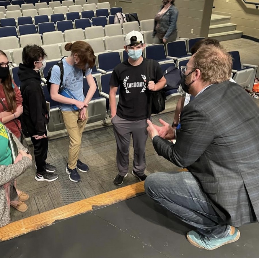 Pleasant Valley chamber choir students gather around composer, Dr. Eric Barnum, to ask questions regarding his career and to gain perspective on the meaning behind his choral piece, “The Sounding Sea.”