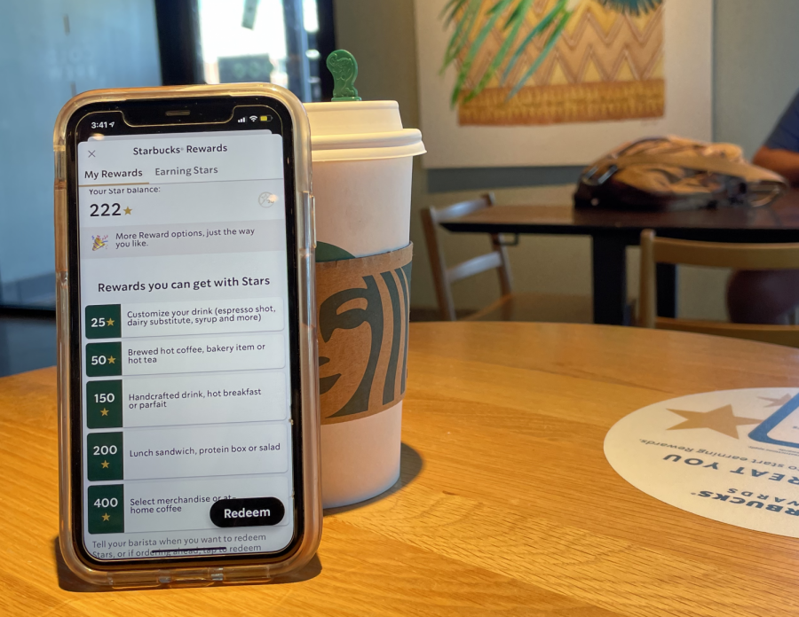 A student earns stars towards free coffee on their Starbucks rewards app after buying a new fall drink.