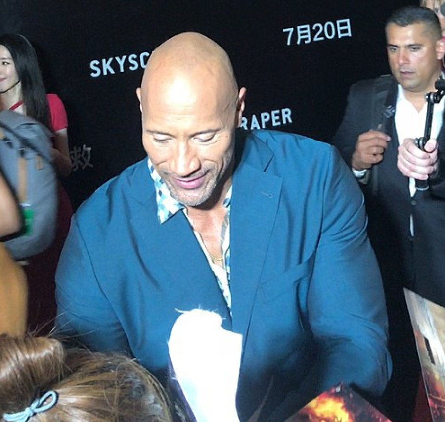 Dwayne Johnson embraces his fans at one of his movie’s pre-release events.