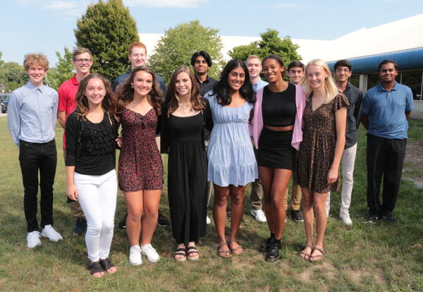 Pleasant Valley’s 14 National Merit semifinalists from the class of 2022 pose for a photo in front of Pleasant Valley High School.