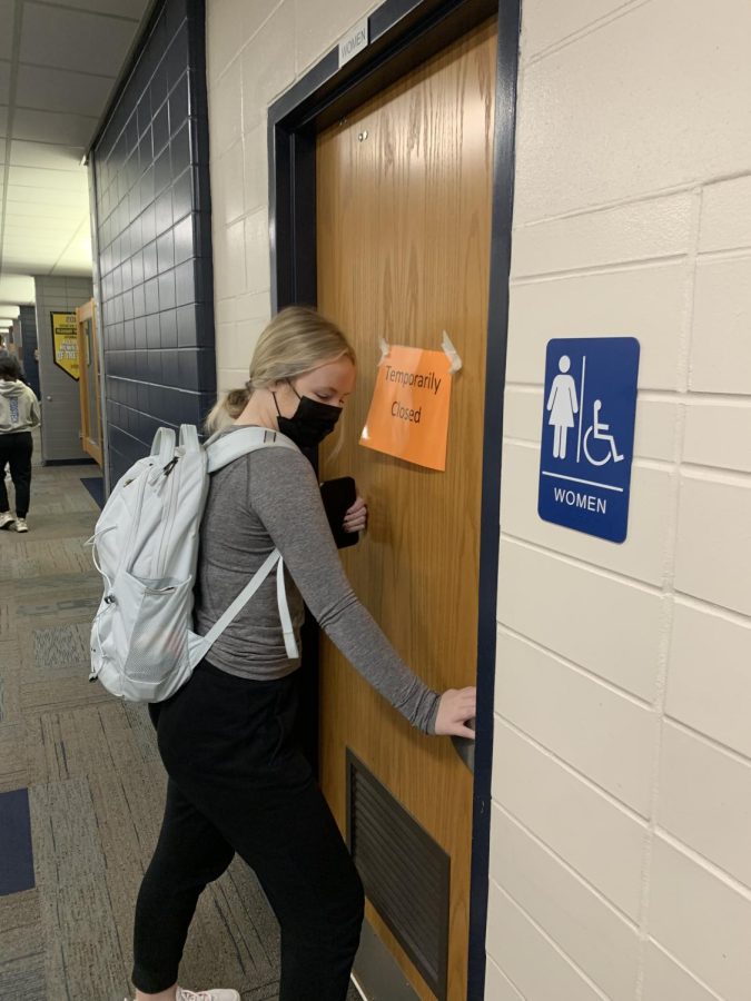 Senior Jillian Keppy tries to open the bathroom door during passing period. 
