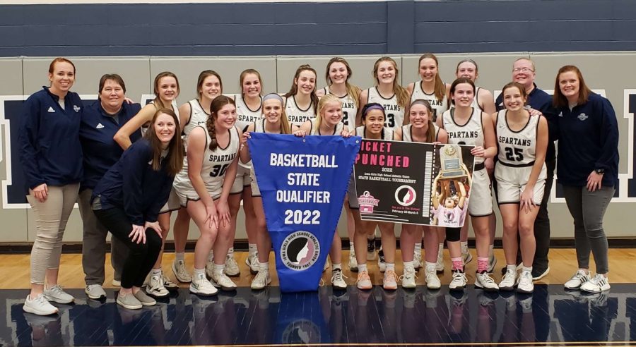 Pleasant Valley girls basketball poses with the State Qualifier banner after clinching a trip to the State Tournament.