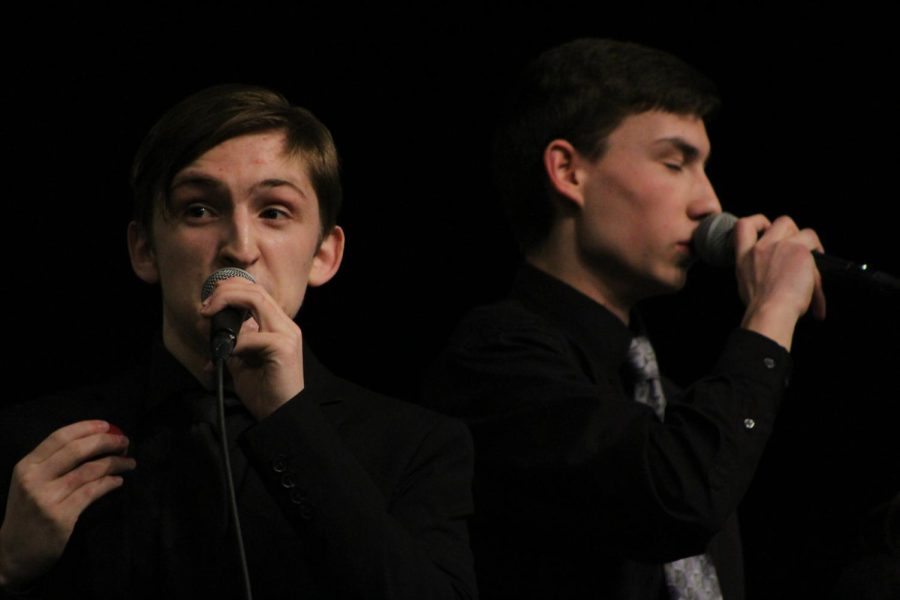 Junior Caleb Swinney (front) and junior Bryce Vining (back) sing expressively in acapella jazz group Leading Tones.