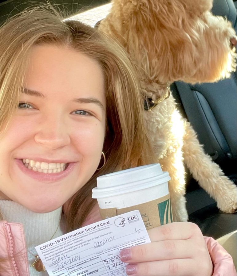 Caroline Sierk poses with her vaccine card after receiving her COVID-19 booster shot. These vaccines are the first time mRNA vaccine technology has been implemented and FDA approved. 