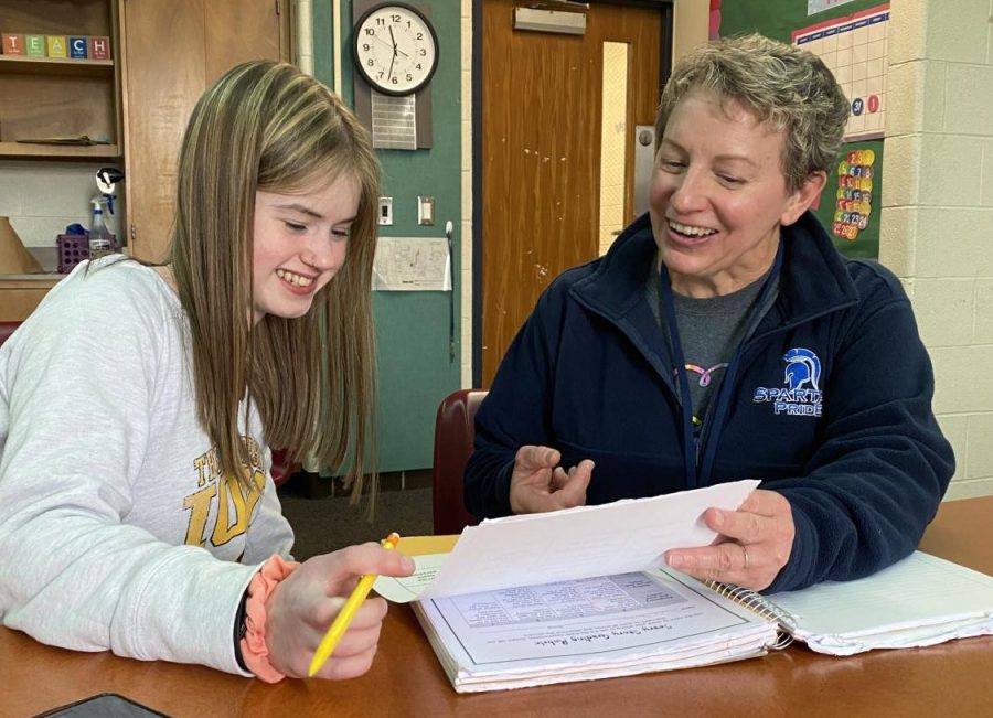 Special Needs Aide Jodi Mitchell assists sophomore Trista Jacobs with her homework, as Mitchell discusses the inequities of special education staff pay. 