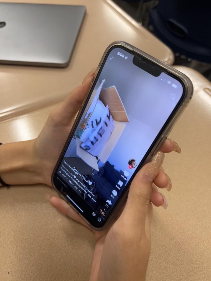 Senior Ava Hahn watches a Shein haul via TikTok. 
