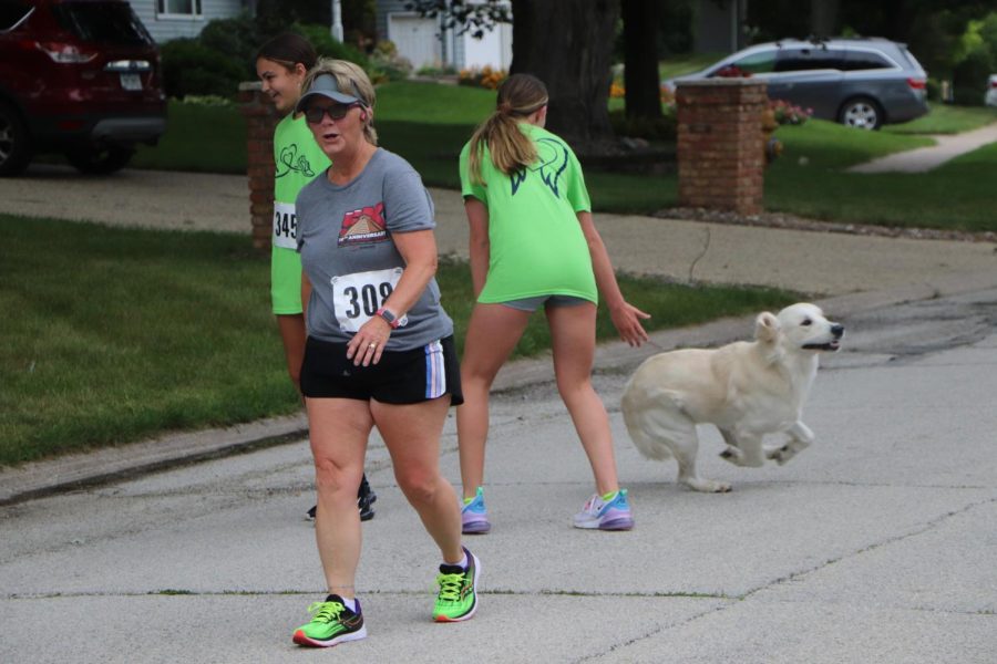 Runners get a visit from a furry friend at the two mile marker of the 5k.