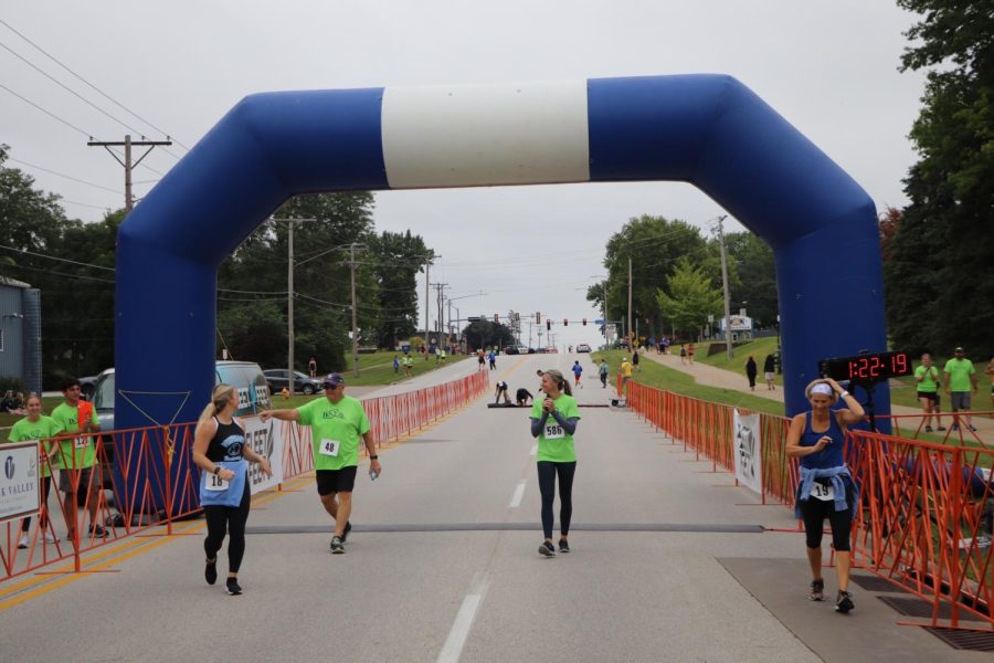 Runners crossing the finish line of the 5k.