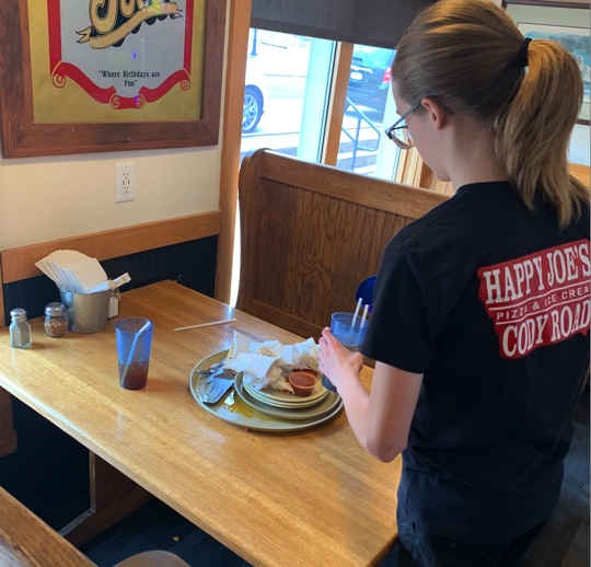  Landon Giese cleaning off a table at the LeClaire happy joes on Oct. 16th.