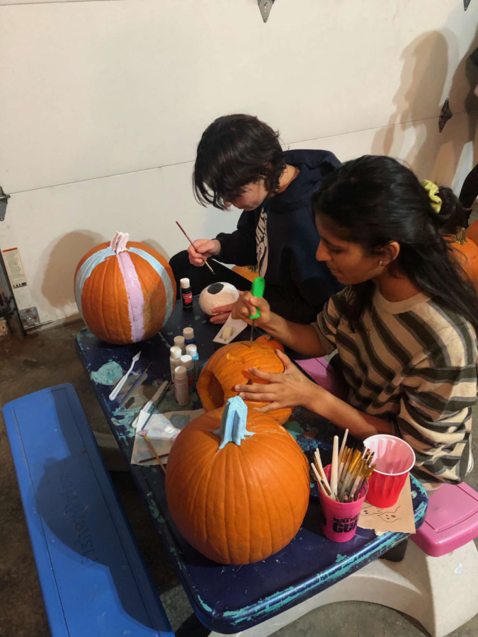 Students painting pumpkins for the Halloween season. 