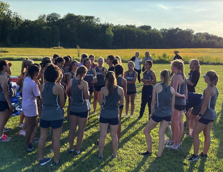 The PV girl’s cross-country team having a meeting after their first meet of the season, at Iowa City.
