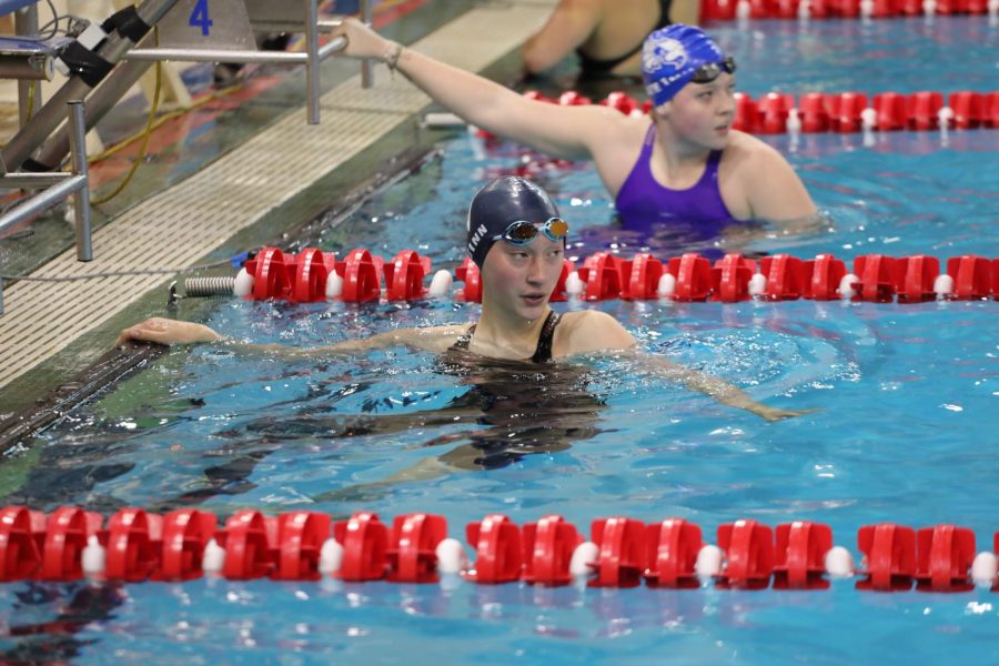 Cait Quinn looks up at the finishing times right after finishing the 500 freestyle.