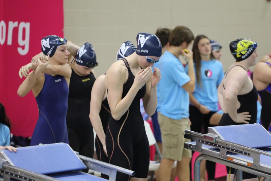 400 freestyle relay team, Cait Quinn, Savannah Smith, Dawsyn Green, and Lauren Kathan, line up behind the block before the race.