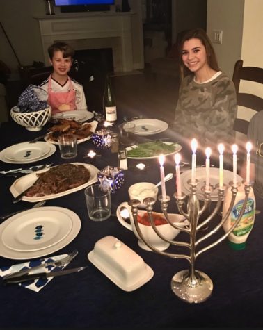 Sophomore Bennett Teitle and his sister, Lila, celebrating Hanukkah with a traditional dinner. 
