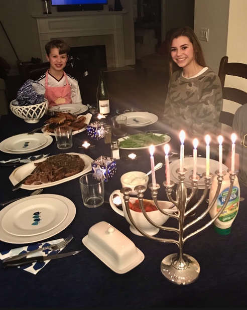 Sophomore+Bennett+Teitle+and+his+sister%2C+Lila%2C+celebrating+Hanukkah+with+a+traditional+dinner.+%0A