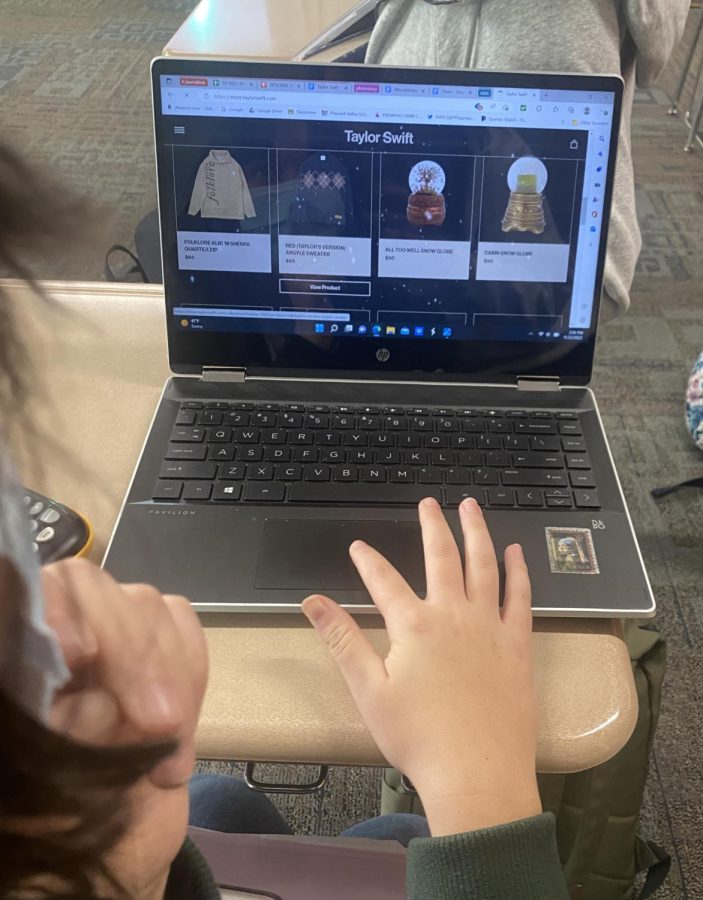 Senior Leila Assadi, a long time Taylor Swift fan, scrolls on Swift’s website looking at the prices of the new holiday collection.