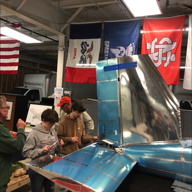 Students from PV, North Scott, and Bettendorf work together on the tail cone of the RV-12 with assistance from EAA mentors. 
