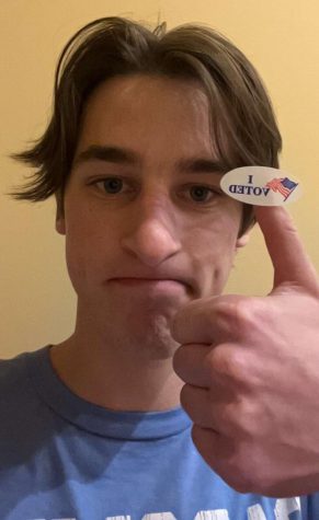 Senior Sam brown poses with the I Voted sticker after participating in the midterm elections for the first time.