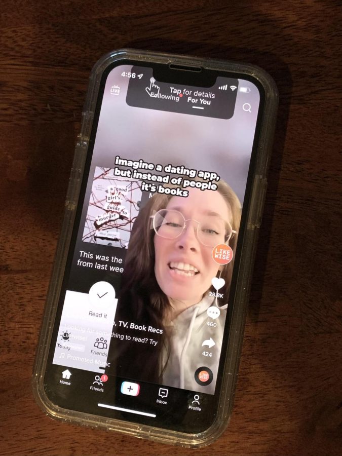 A phone displays a TikTok ad for the brand Likewise, one example of a paid advertisement on social media targeted towards Gen Z.