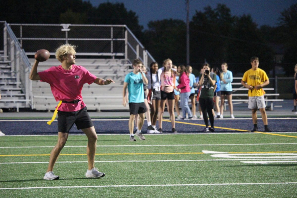 Senior Spencer Roemer throwing the football at the powderpuff fundraiser event. Photocredit to Spartan Shield.