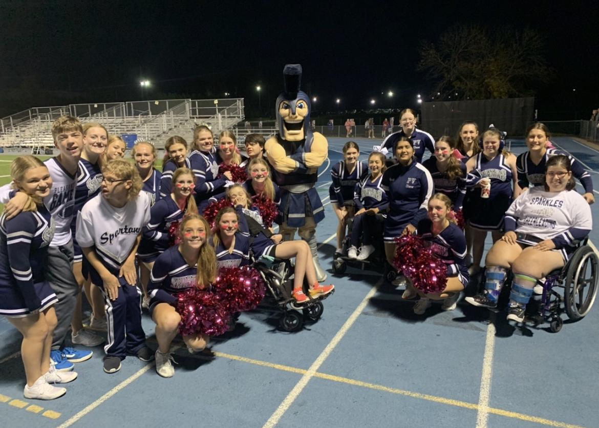 Sparkles cheer squad posing at a PVHS football game.
