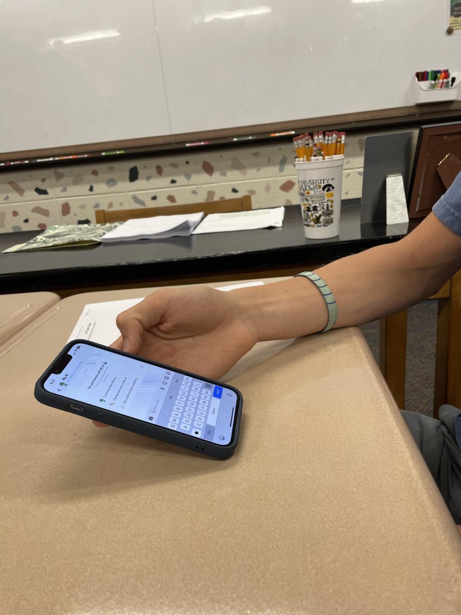 Junior Carson Roman uses artificial intelligence on his phone.