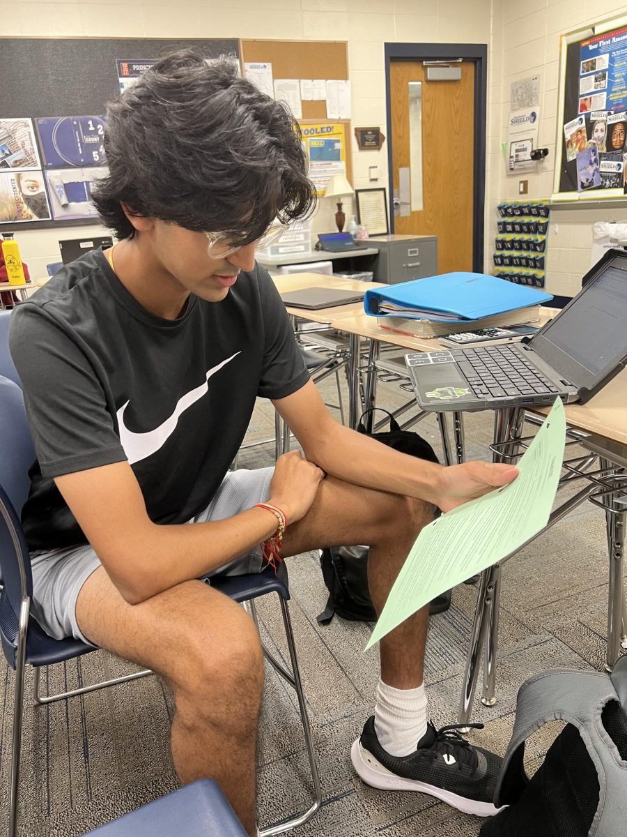 Junior Shivam Patel looks over his class’s curriculum to note the changes made to the late work and grading policy
