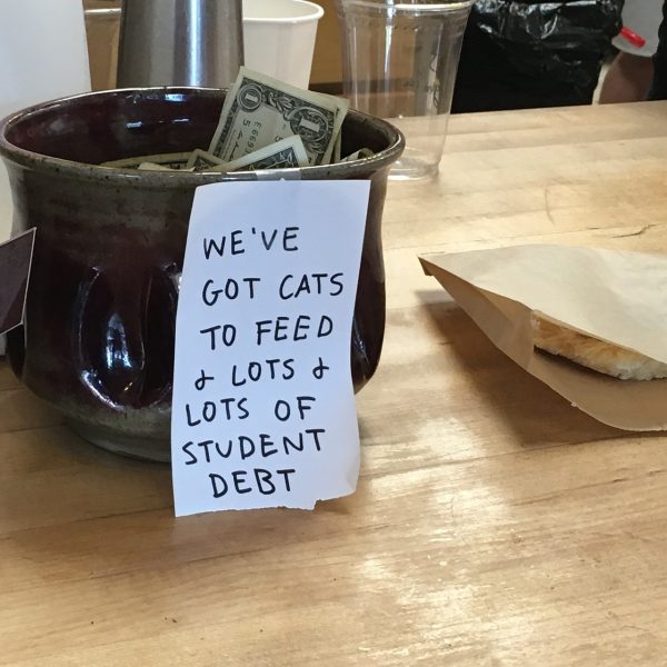 What appears to be a humorous tip jar in one’s home highlights a key detriment to attending college: crippling student loans that are difficult to pay off upon graduation. Photo Credit to: Tad Hanna