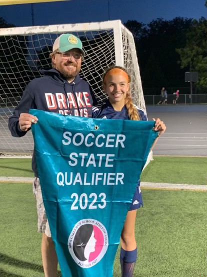 Junior soccer player Sophia Lewis stands with her dad and coach after winning her match to go to the State Tournament. Photo credit to Sophia Lewis. 
