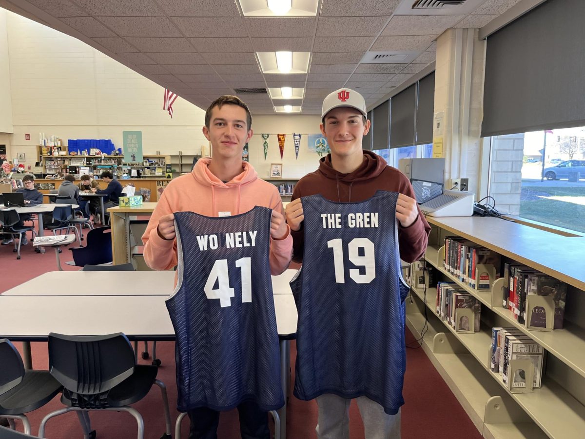 Seniors Kyle Almgen and Tyler Nels hold up their personalized blue crew jerseys after they were handed out on Dec. 12. 