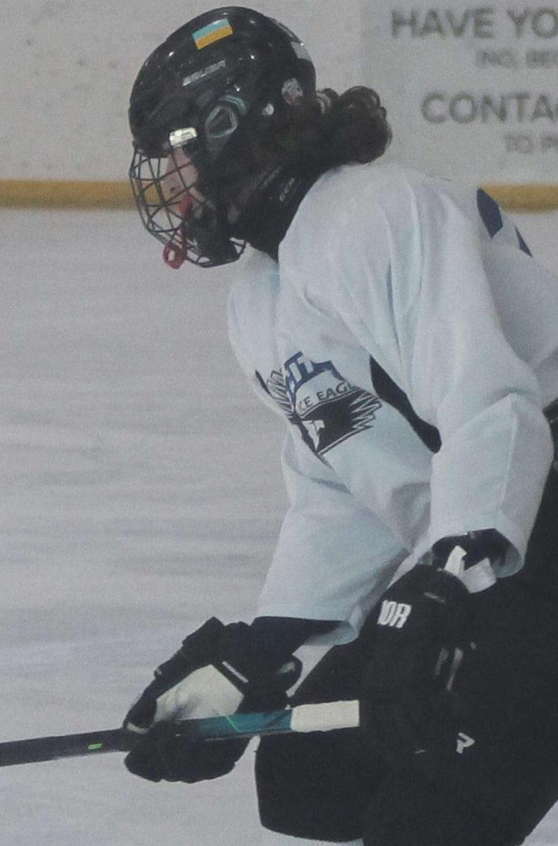 North Scott hockey player Noah Seagram wearing a neck guard while playing Ice Hockey.