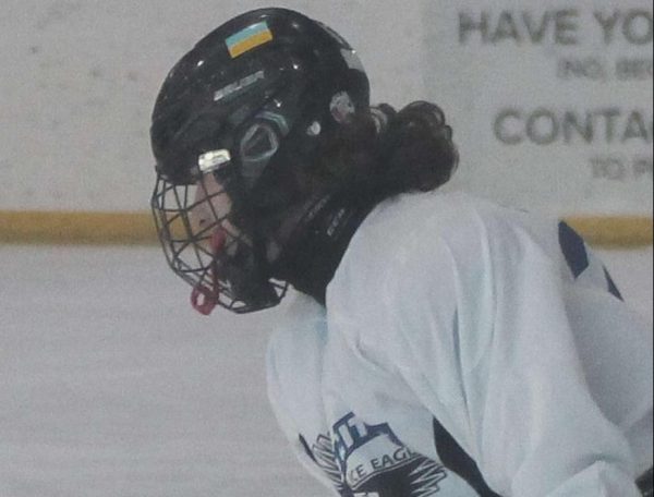 North Scott hockey player Noah Seagram wearing a neck guard while playing Ice Hockey.