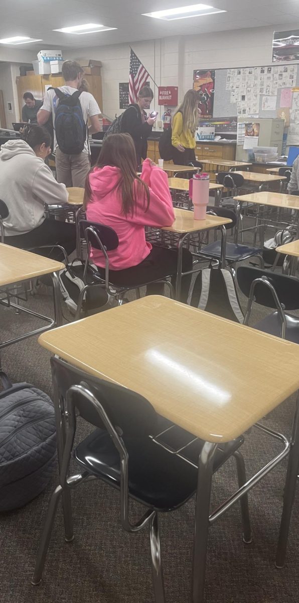 Teachers move desks apart to prevent cheating on test day.