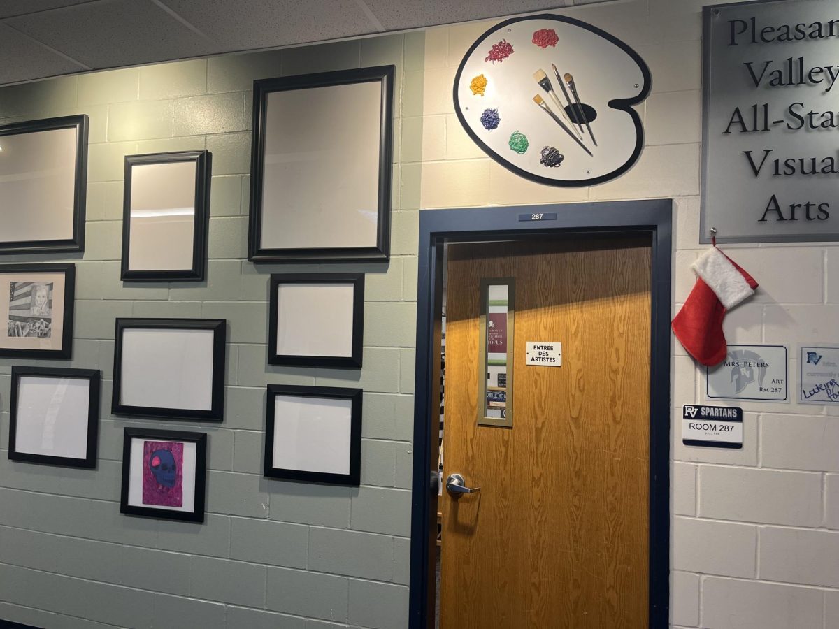 The art hallway at Pleasant Valley High School, with some of the students works hanging on the wall. The art classroom is also pictured, where students take a majority of the art classes.
