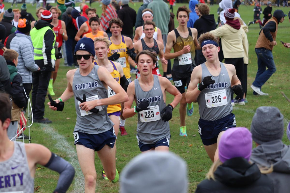 Senior Max Sorgenfrey, junior Cameron Gotto and junior Jack Perry (left to right) start out strong at the Iowa Boys Cross Country State Meet.