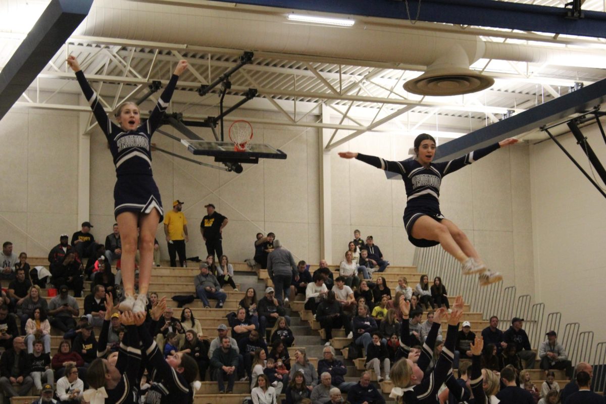 Isabella Moore and Aubree Lutz soar high at PV Varsity Boys basketball game vs Bettendorf. Photo credit to Gabi Ragins.