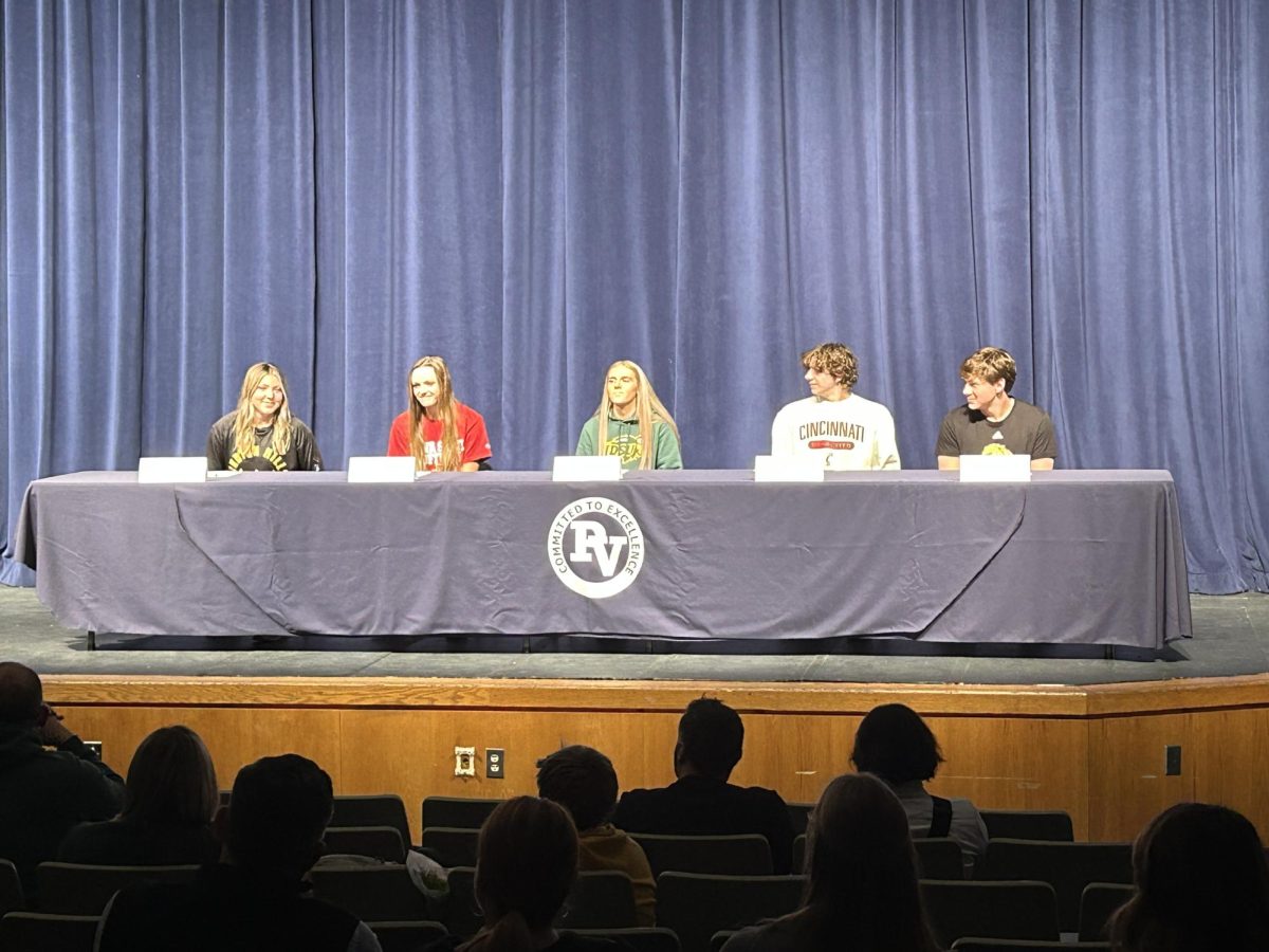  (right to left) Mary Paige Withers, Jessie Clemons, Morgan Russmann, Owen Chiles, Will Gorman all wait eagerly to sign their contracts.