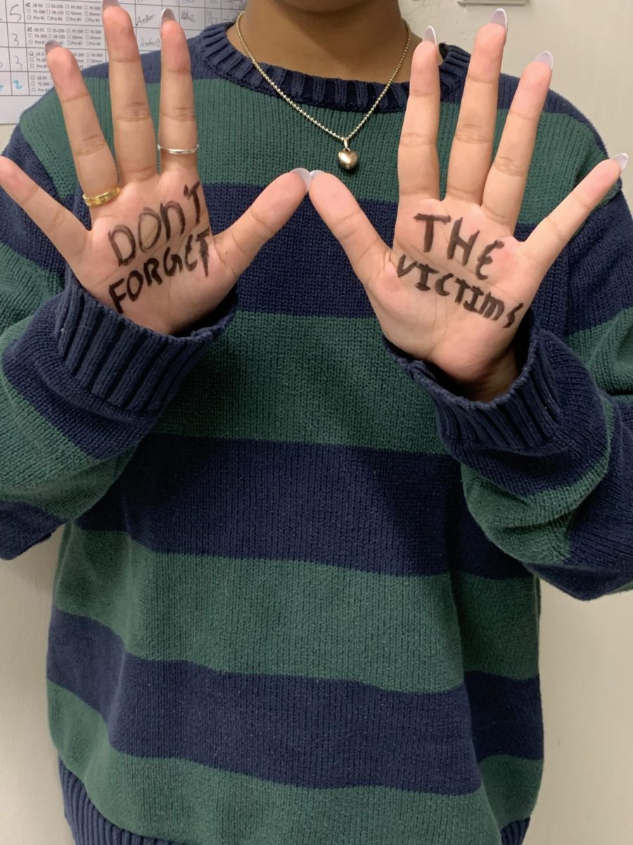 “Don’t forget the victims” written on Priya Sureshs’ hands, expressing how true crime shows shouldn’t forget the victims when they’re talking about the killers. 